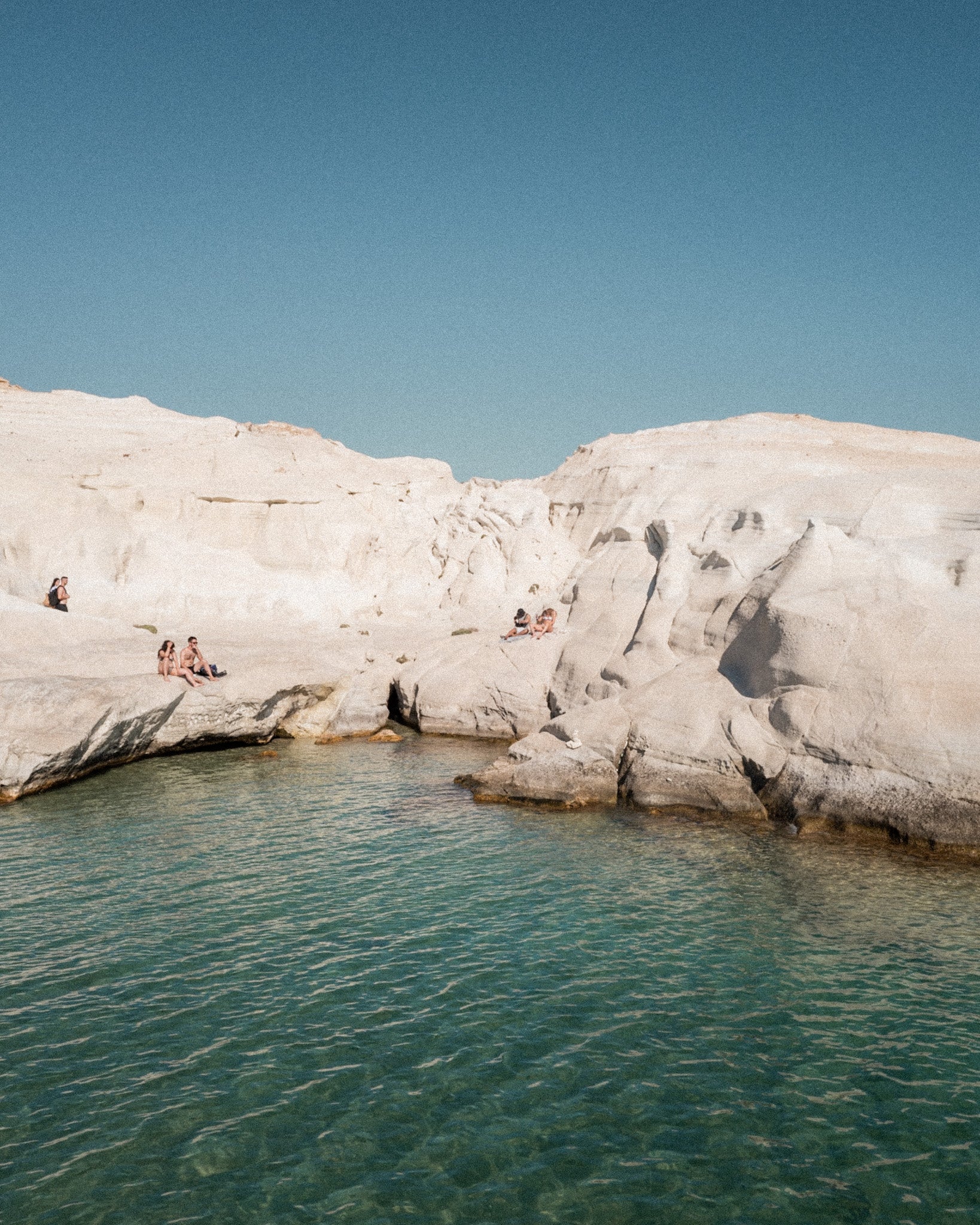 Sarakiniko I – Milos fine-art print by Sam Smeaton — white volcanic cliffs and turquoise Aegean sea under clear Cycladic sky