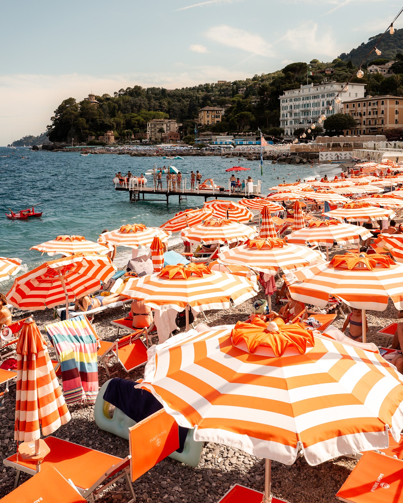 Vertical fine-art photography print of Santa Margherita beach umbrellas by Sam Smeaton — vibrant orange tones along the Italian Riviera.