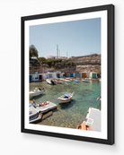 Mandrakia II – Milos fine-art print in black frame by Sam Smeaton — Mediterranean wall art featuring calm turquoise water and Cycladic architecture
