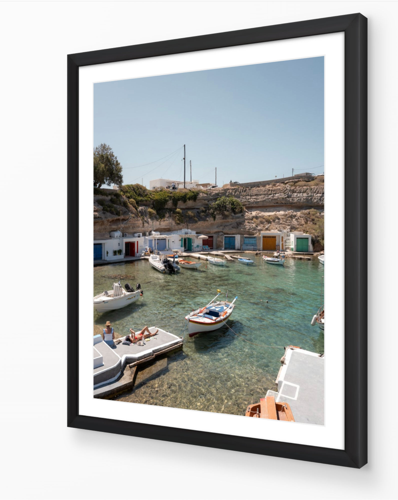 Mandrakia II – Milos fine-art print in black frame by Sam Smeaton — Mediterranean wall art featuring calm turquoise water and Cycladic architecture