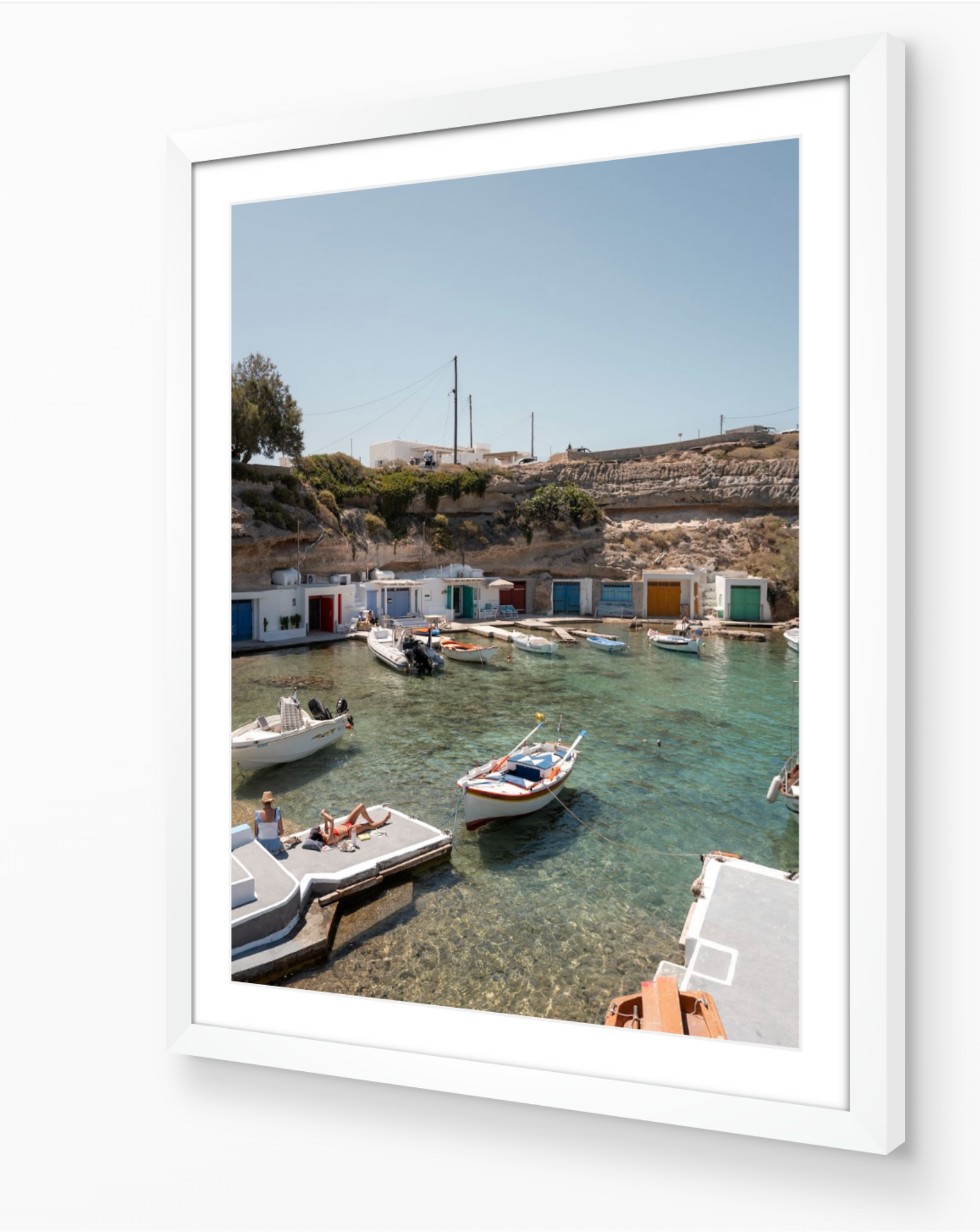 Mandrakia II – Milos fine-art print in white frame by Sam Smeaton — Greek island photography of boats anchored in crystal-clear water, Milos Greece