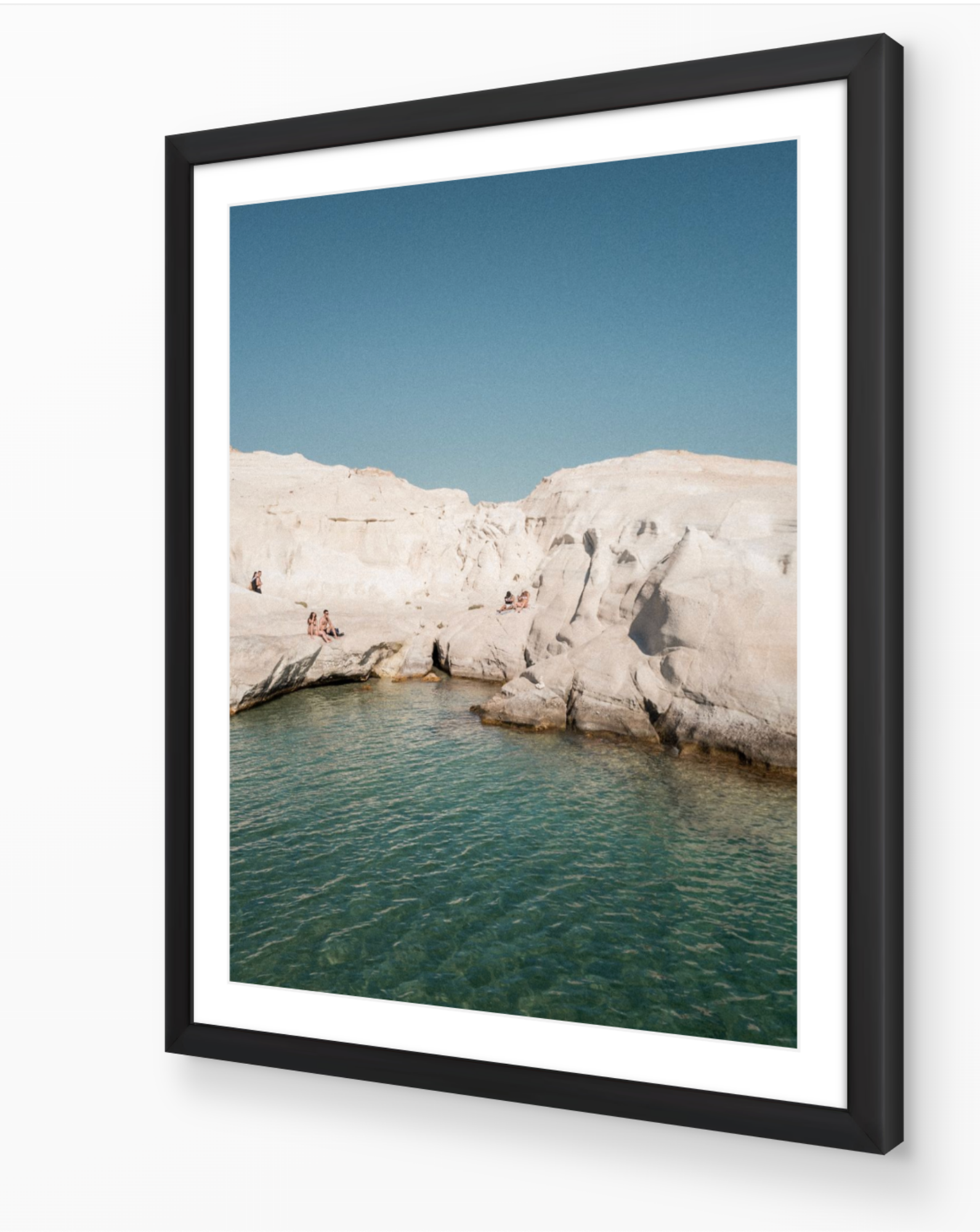 Sarakiniko I – Milos fine-art print in black frame by Sam Smeaton — minimalist Greek coastal landscape featuring soft white rock and calm turquoise water