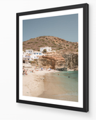 Agali Beach – Folegandros fine-art print in black frame by Sam Smeaton — warm Cycladic coastal scene with cliffs, clear sea, and white village architecture