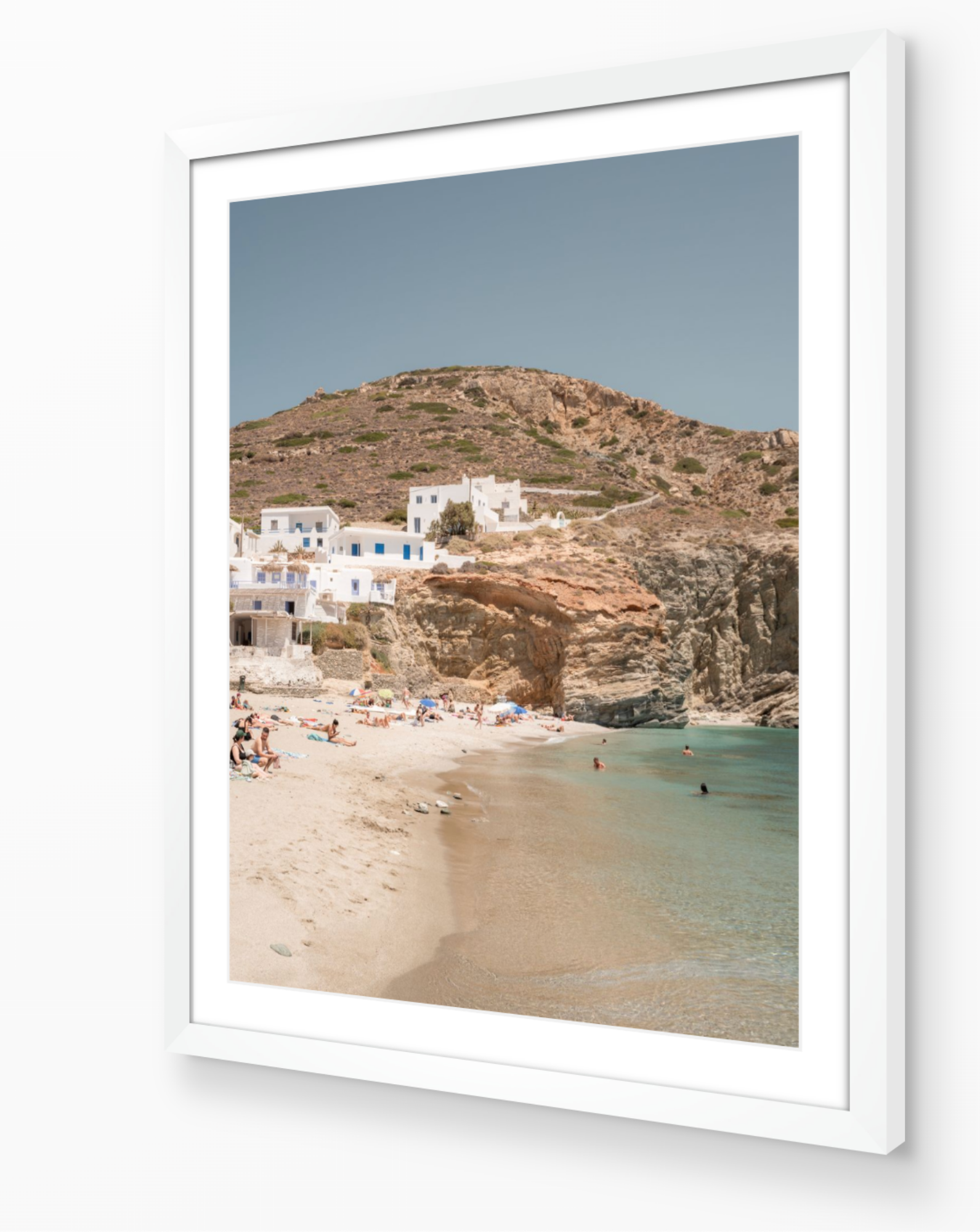 Agali Beach – Folegandros fine-art print in white frame by Sam Smeaton — minimalist Greek island beach scene featuring soft sand, turquoise water, and white houses