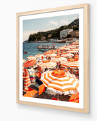 Santa Margherita beach umbrella print in oak frame — warm vertical Italian Riviera fine-art wall piece by Sam Smeaton.