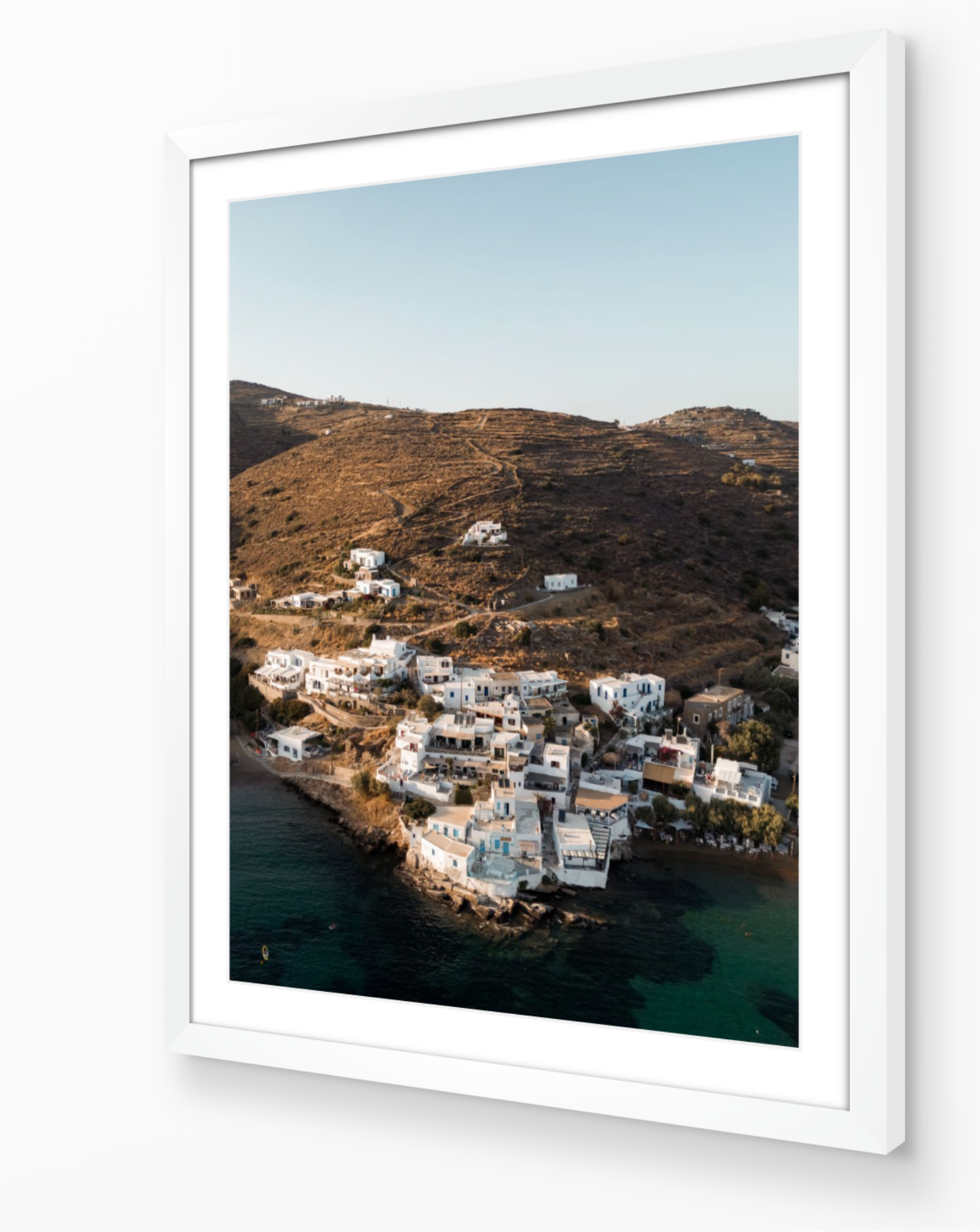 Sifnos Serenity fine-art print in white frame by Sam Smeaton — soft Mediterranean landscape featuring white Cycladic homes and warm coastal tones
