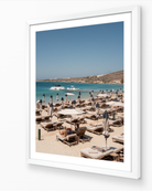 Crios Beach – Paros fine-art print in white frame by Sam Smeaton — Aegean island photography featuring sunbeds and calm blue sea