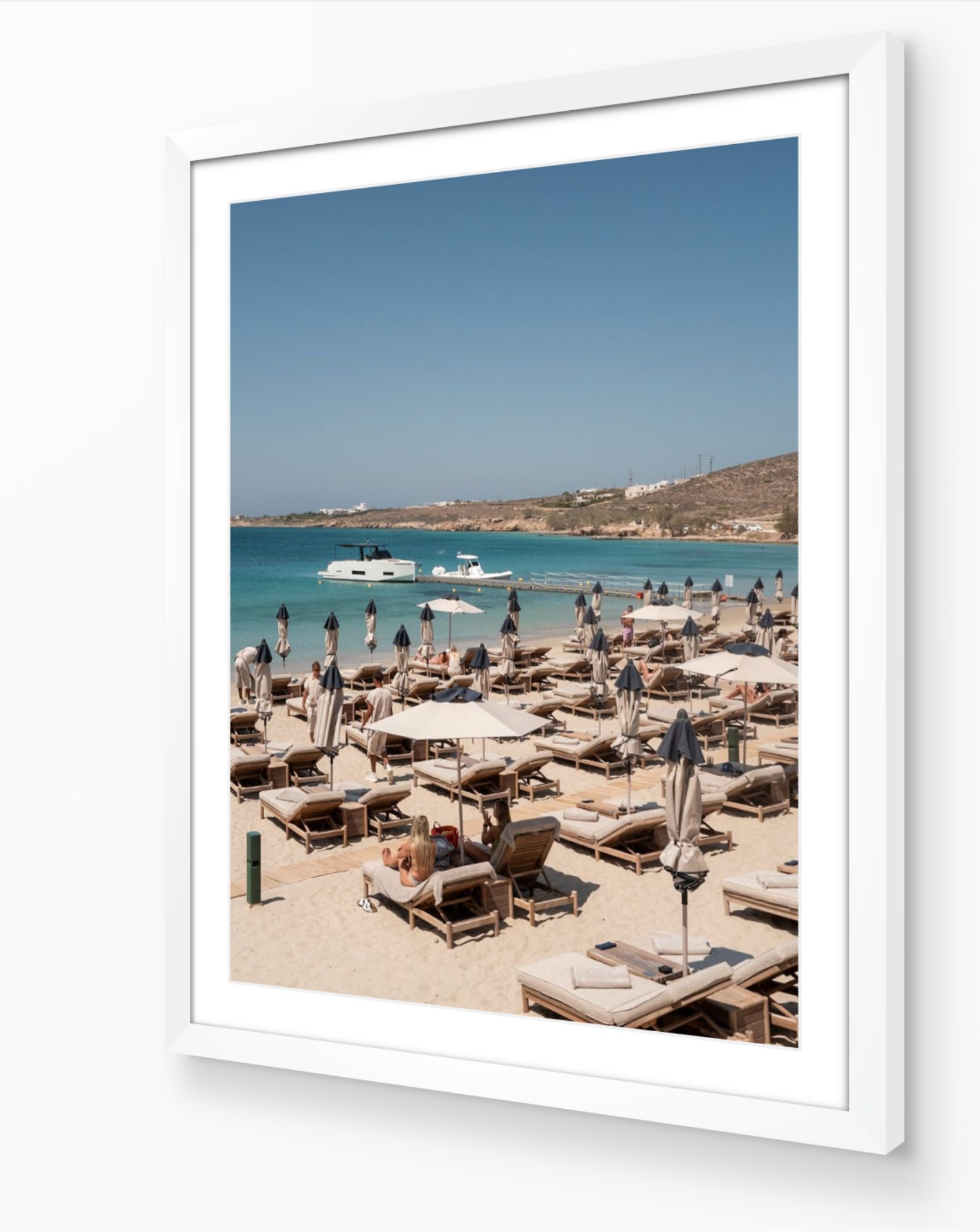 Crios Beach – Paros fine-art print in white frame by Sam Smeaton — Aegean island photography featuring sunbeds and calm blue sea
