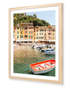 Portofino II fine-art print by Sam Smeaton — ochre-toned façades and glimmering Mediterranean waters, framed in natural oak for warm, timeless charm.