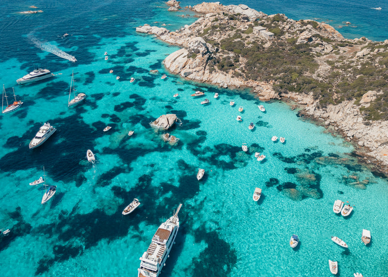 Fine-art photography print of La Maddalena by Sam Smeaton — aerial view of Sardinia’s turquoise bay and anchored boats, printed on premium matte fine-art paper, 60 × 40 cm.