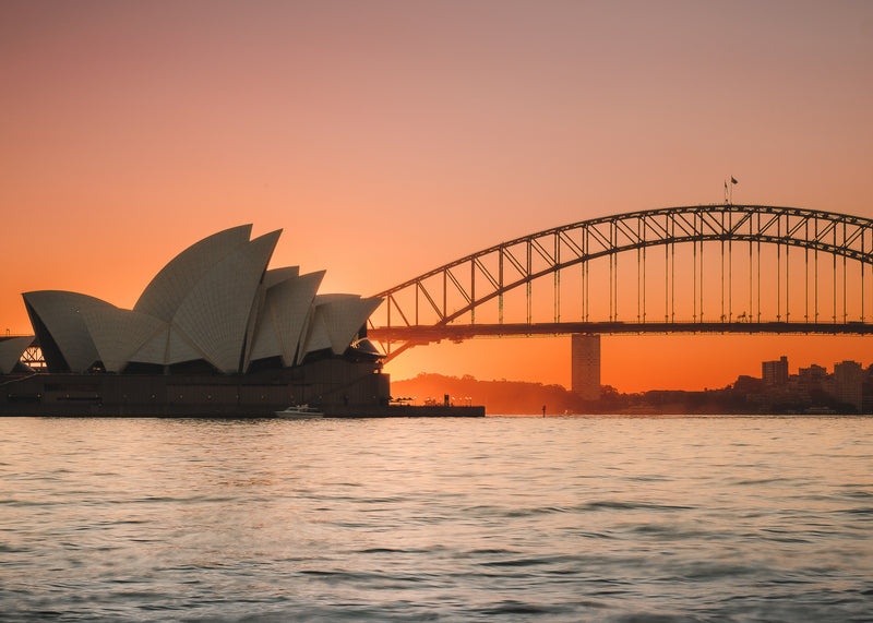 Opera House and Harbour Bridge at Sunset fine-art print by Sam Smeaton — golden dusk light over Sydney Harbour with calm water and iconic skyline silhouettes
