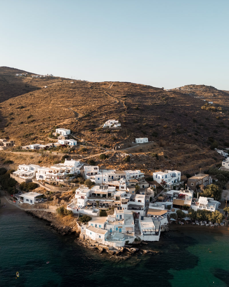 Sifnos Serenity fine-art print by Sam Smeaton — whitewashed houses along the Sifnos coastline under golden afternoon light and sun-baked hills