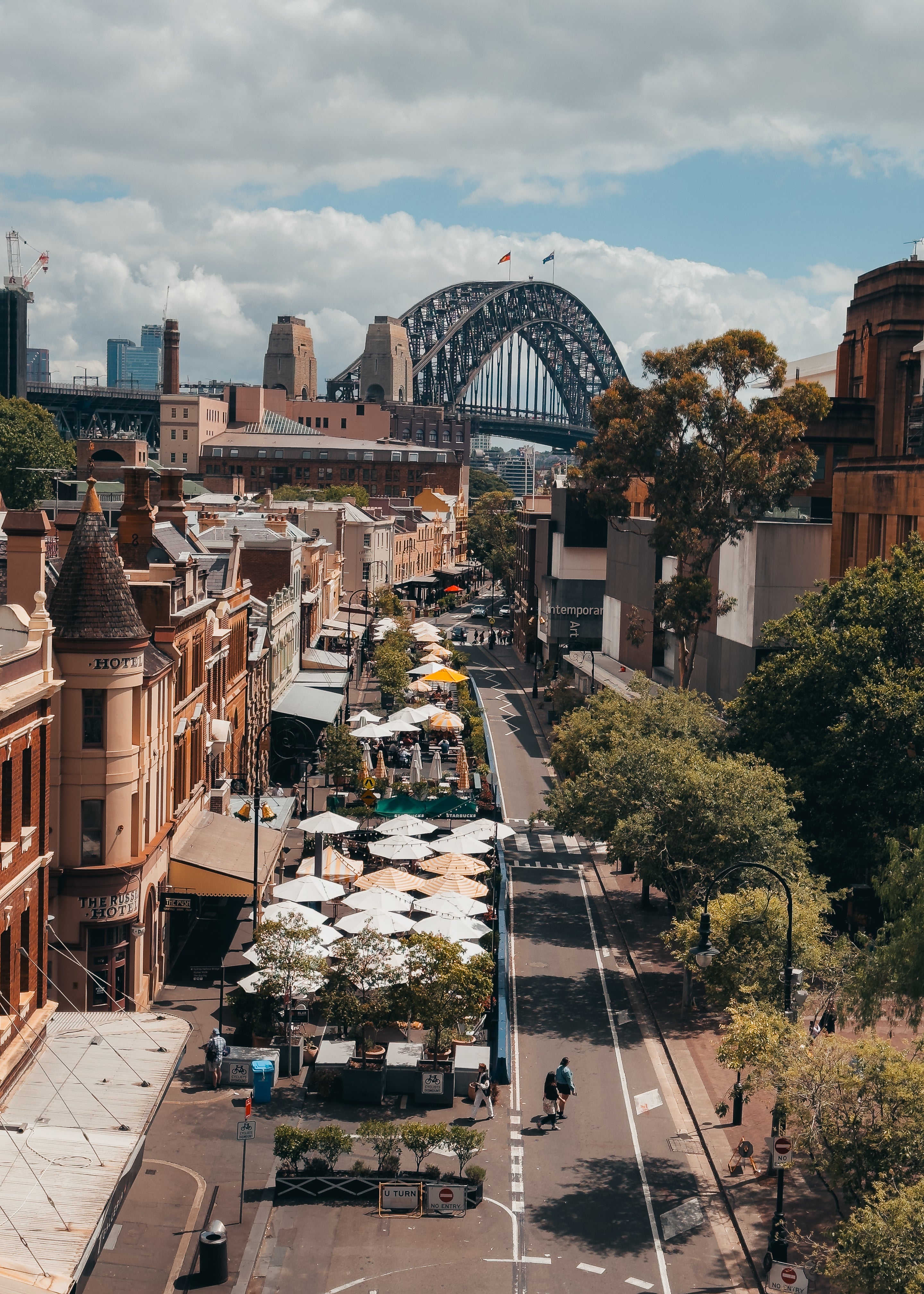 The Rocks – Sydney Harbour Bridge fine-art print by Sam Smeaton — terracotta rooftops and historic buildings overlooking the Sydney Harbour Bridge under soft afternoon light