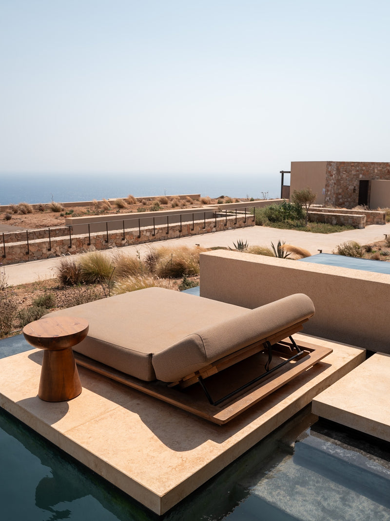 Terrace with stone seating and sea view, Mediterranean hotel photography.