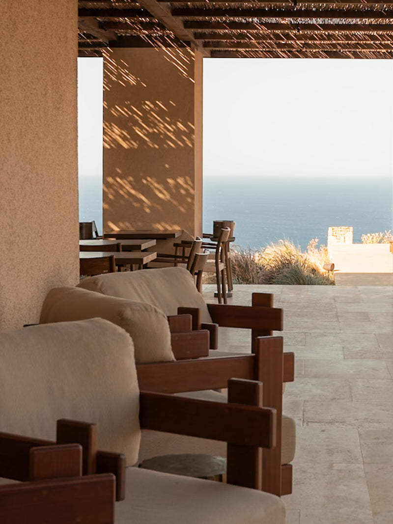 Ocean-view terrace with soft sunset light, boutique hotel in the Aegean.