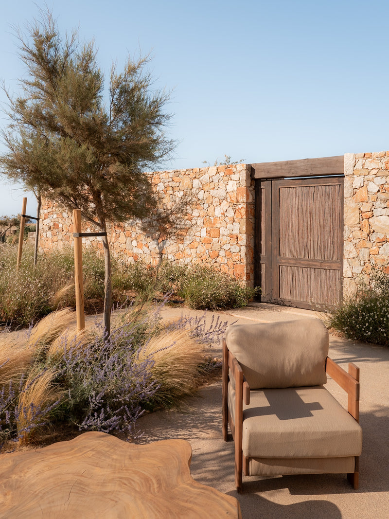 Stone wall and native garden captured in warm tones at a luxury island resort.