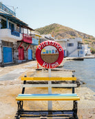 Klima – Milos fine-art print by Sam Smeaton — colourful Greek boathouses, blue shutters, and seafront reflections from Milos island