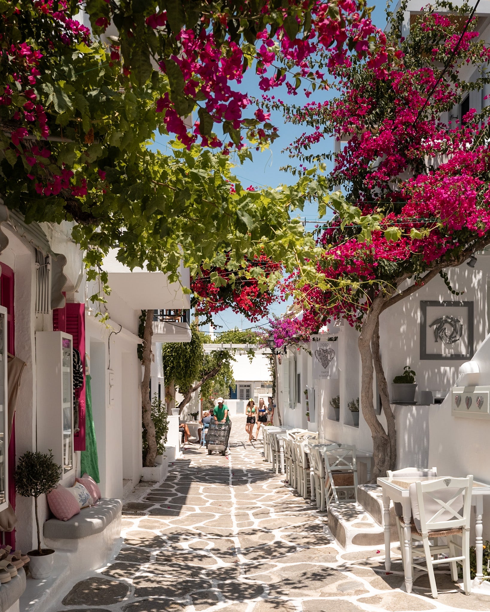 Paros Bougainvillea Lane fine-art print by Sam Smeaton — Greek island photography featuring whitewashed walls, cobblestone paths, and pink bougainvillea in full bloom