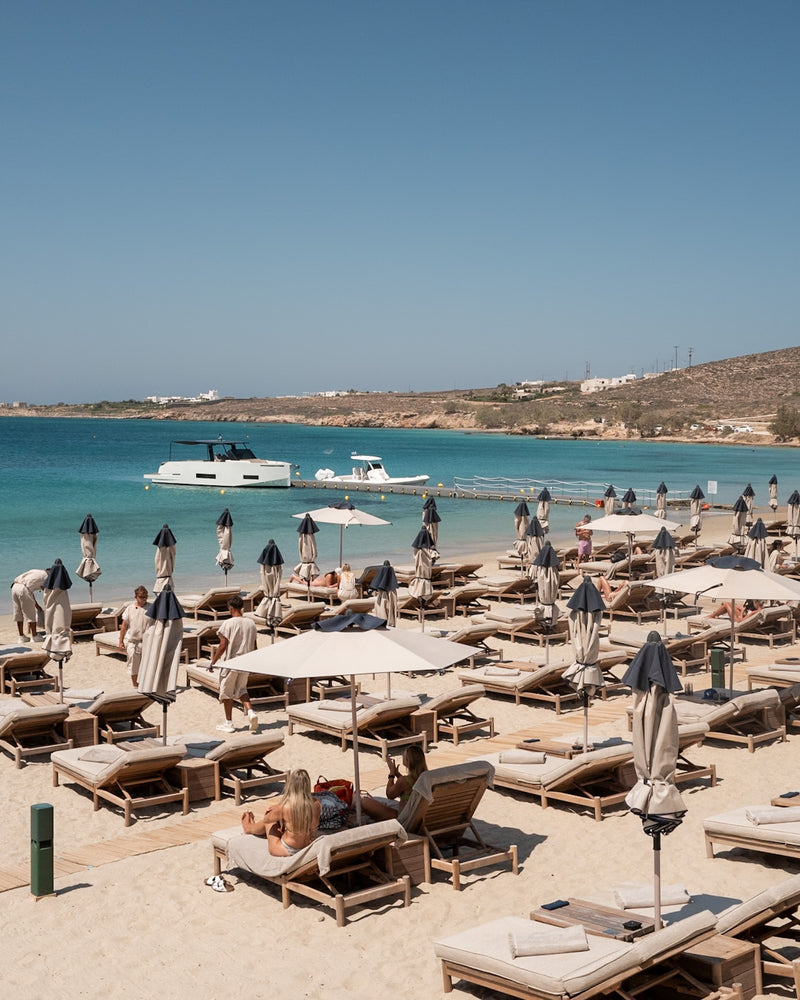 Crios Beach – Paros fine-art print by Sam Smeaton — Greek island photography with teak sun loungers, turquoise Aegean water, and barefoot coastal style