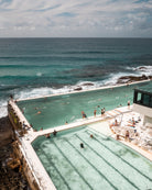 Sydney Icebergs – Bondi Pool fine-art print by Sam Smeaton — vertical aerial view of Bondi’s turquoise ocean pool beside the Pacific with white architecture and calm waves