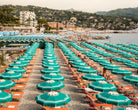 Fine-art photography print of Portofino Beach Club by Sam Smeaton — turquoise umbrellas and terracotta sunbeds along the Italian Riviera, printed on premium matte fine-art paper, 60 × 40 cm.