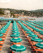 Fine-art photography print of Portofino Beach Club (Vertical Edition) by Sam Smeaton — turquoise umbrellas and orange sunbeds along the Italian Riviera, printed on premium matte fine-art paper, 50 × 75 cm.