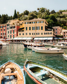 Fine-art photography print of Portofino I by Sam Smeaton — wooden boats and pastel façades on the Italian Riviera, captured in Portofino’s sunlit harbour, printed on premium matte fine-art paper, 50 × 75 cm.