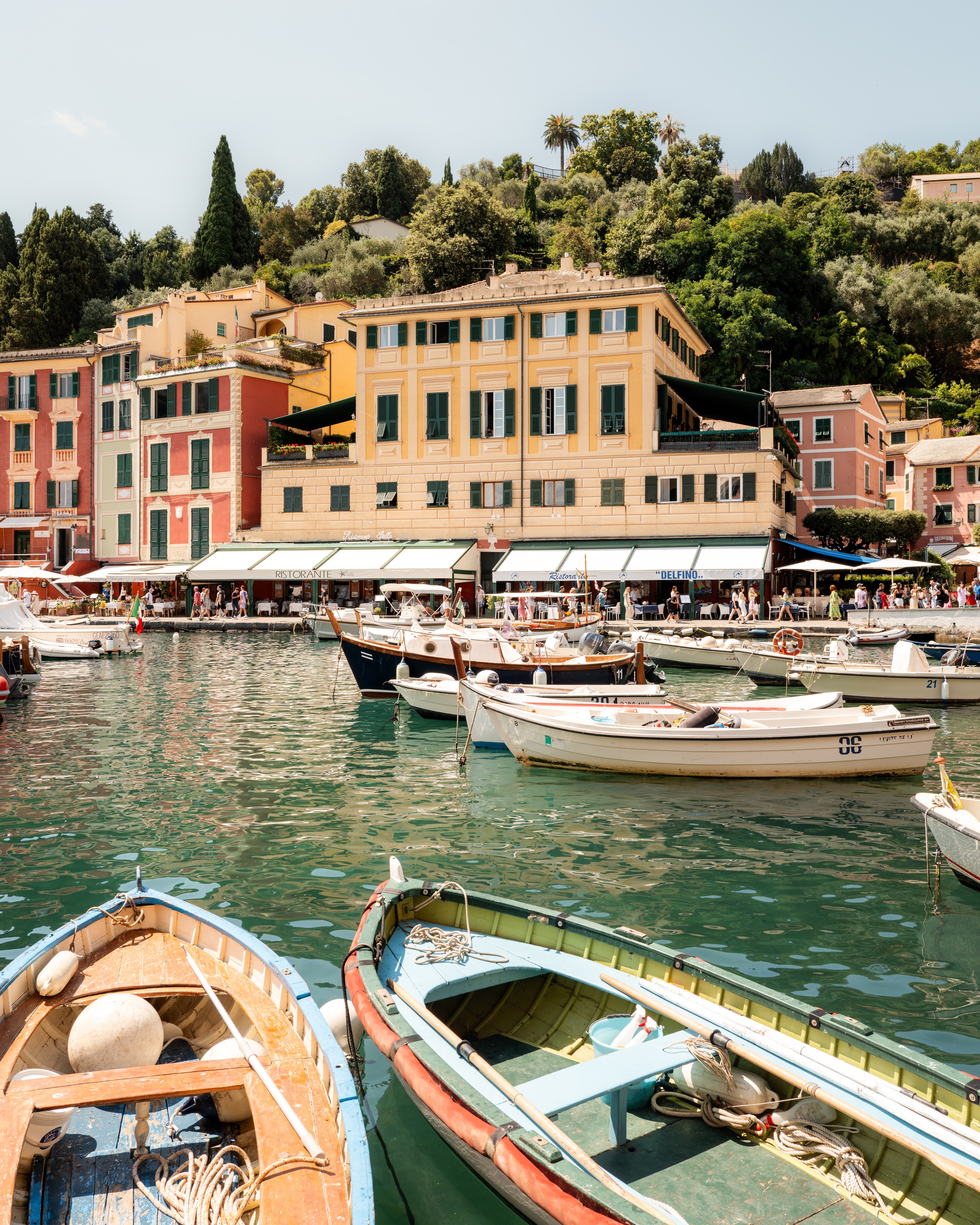 Fine-art photography print of Portofino I by Sam Smeaton — wooden boats and pastel façades on the Italian Riviera, captured in Portofino’s sunlit harbour, printed on premium matte fine-art paper, 50 × 75 cm.
