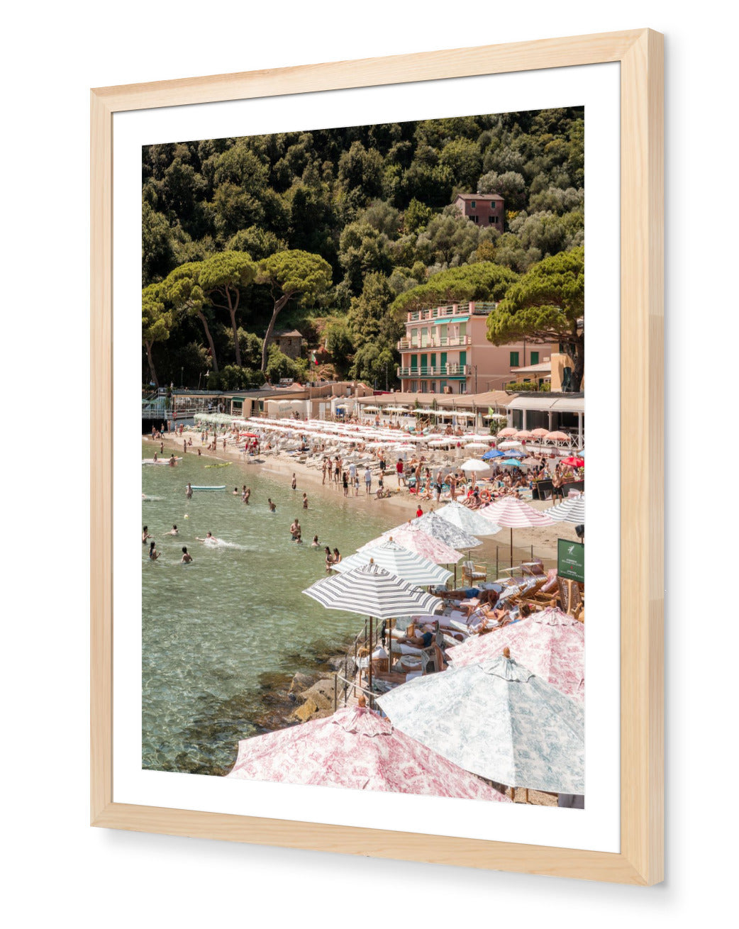 Paraggi Beach fine-art print by Sam Smeaton — Italian Riviera summer scene with striped umbrellas and turquoise water, framed in natural oak for warm Mediterranean tones.