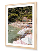 Paraggi Beach fine-art print by Sam Smeaton — Italian Riviera summer scene with striped umbrellas and turquoise water, framed in natural oak for warm Mediterranean tones.