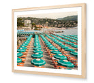 Portofino Beach Club fine-art print by Sam Smeaton — turquoise umbrellas and Italian sunbeds, framed in natural oak for warm, timeless Riviera elegance.