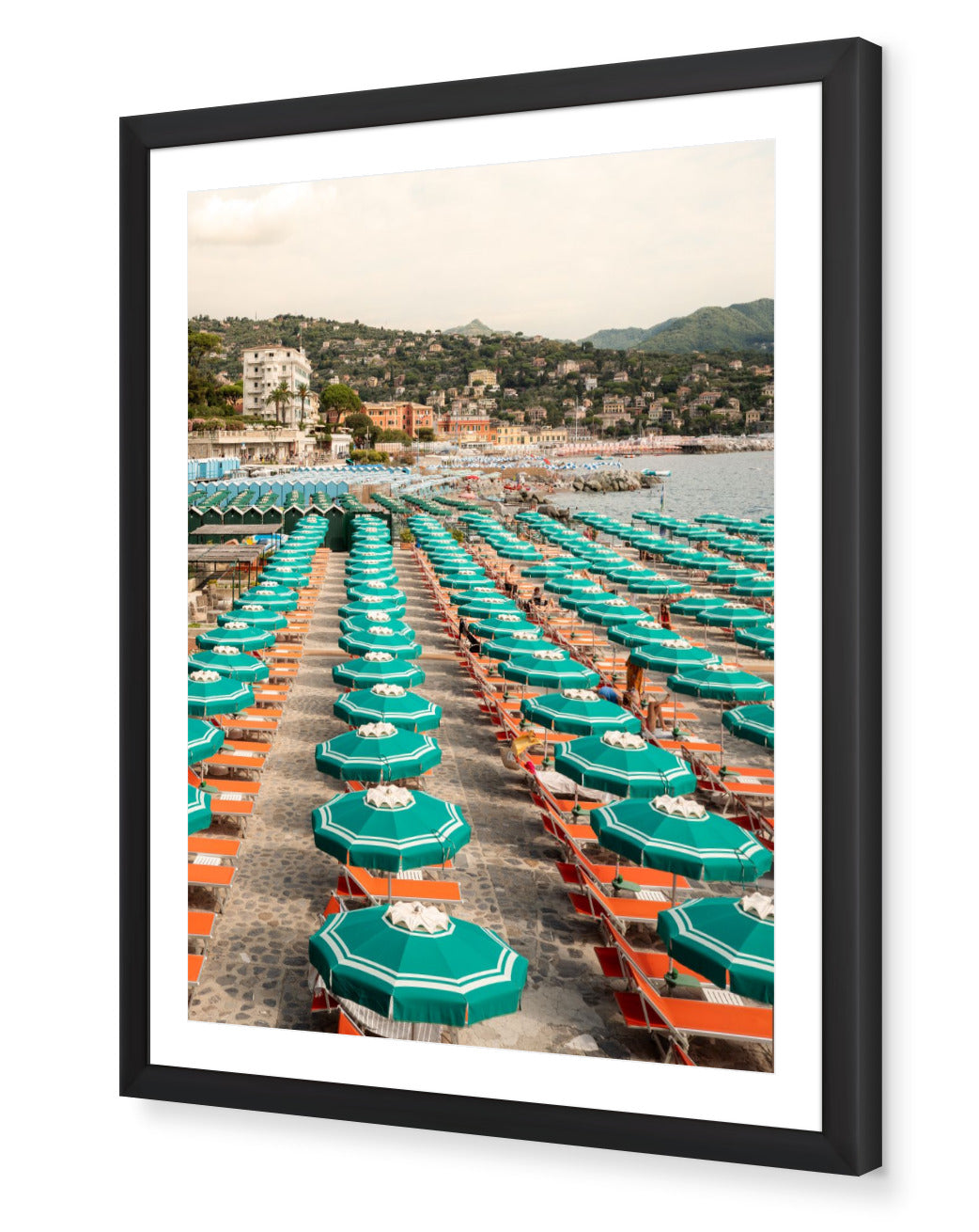Portofino Beach Club fine-art print by Sam Smeaton — turquoise umbrellas and sunbeds on the Italian Riviera, framed in black for dramatic Mediterranean contrast.