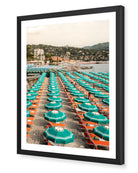 Portofino Beach Club fine-art print by Sam Smeaton — turquoise umbrellas and sunbeds on the Italian Riviera, framed in black for dramatic Mediterranean contrast.