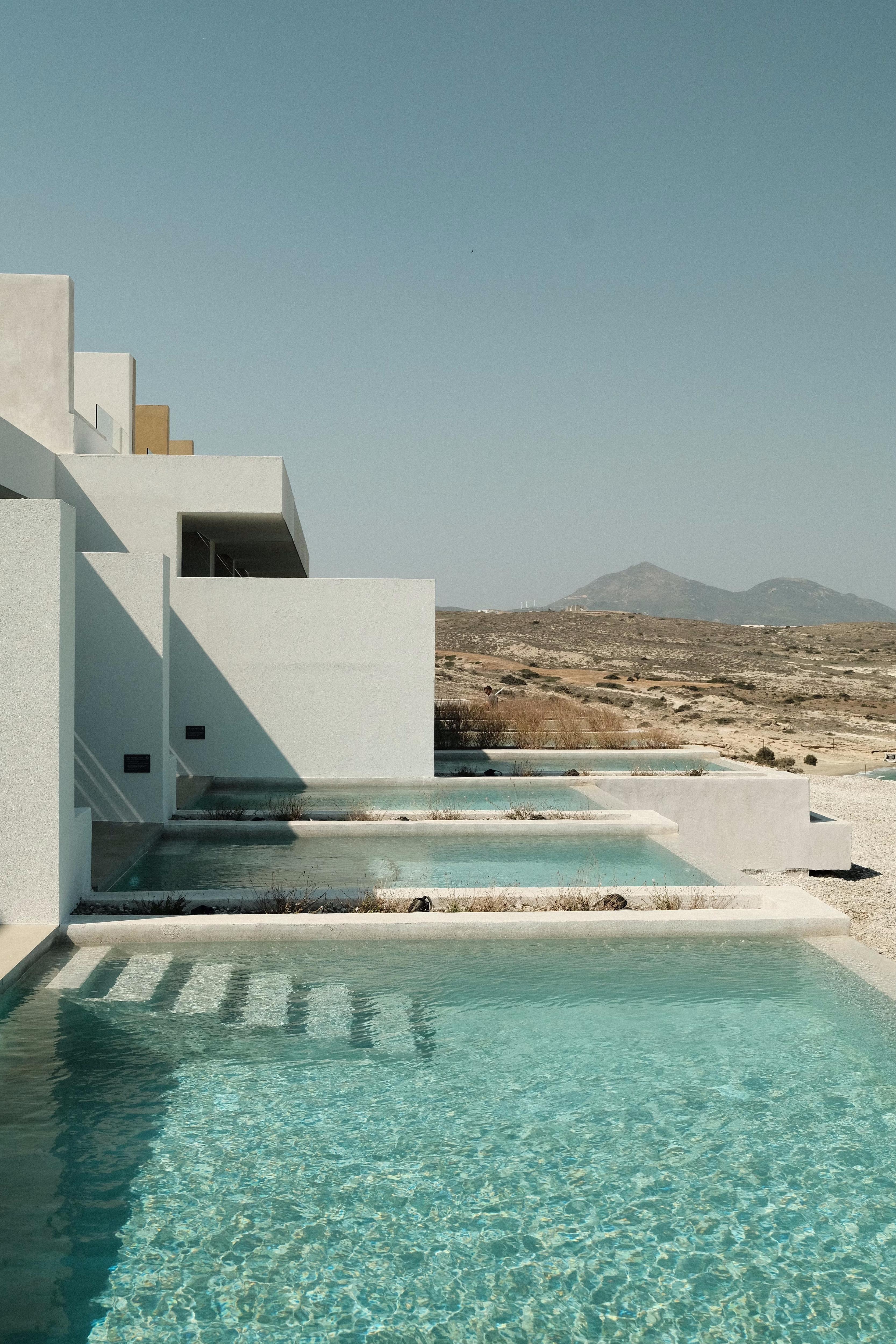 Private Pools – Milos fine-art print by Sam Smeaton — Greek island photography featuring modern Cycladic architecture and turquoise infinity pools