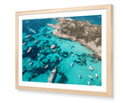 La Maddalena fine-art print by Sam Smeaton — aerial turquoise seascape framed in natural oak for soft warmth and timeless Italian style.