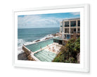 Sydney Icebergs – Bondi Pool fine-art print in white frame by Sam Smeaton — minimalist aerial view of Bondi’s ocean pool with modern architecture and calm turquoise water